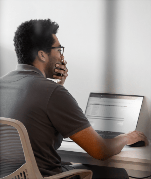 Man sitting at a desk with laptop open