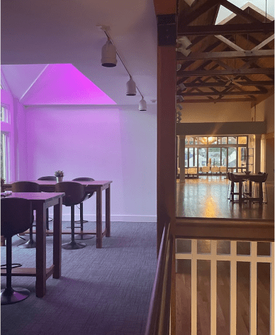 An open floor office with hightop tables and chairs